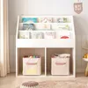 A white bookshelf filled with children's books and storage bins. Podgląd zdjęcia produktu