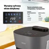 A close-up shot of a modern air fryer on a kitchen counter, highlighting its digital display and control panel, with text overlays describing its features. Podgląd zdjęcia produktu