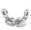 A pair of silver heart-shaped charms with puzzle pieces, adorned with colorful gemstones, are displayed against a white background. Anteprima dell’immagine prodotto