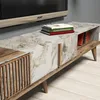 A close-up view of a TV stand with a marble-patterned top and wooden accents, featuring books and glasses on top. Náhľad obrázku produktu