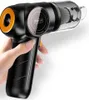 A hand holding a black and orange portable vacuum cleaner. Produktbild-Vorschau
