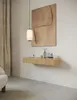 A minimalist interior scene featuring a floating shelf with decorative items, a pendant light, and artwork on the wall. Produktbild-Vorschau