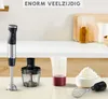 A kitchen counter scene featuring a hand blender and its accessories, with text overlay. Produktbild-Vorschau