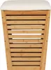 A front view of a bamboo laundry hamper with a cream-colored seat cushion on top. Anteprima dell’immagine prodotto