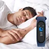 A man sleeping in bed with a fitness tracker on his wrist. Produktbild-Vorschau