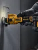 A hand wearing a glove is using a DeWALT cordless drywall router to cut into a wall. Podgląd zdjęcia produktu
