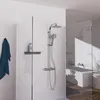 A modern bathroom shower area with a shower system and a bathtub visible in the reflection. Podgląd zdjęcia produktu