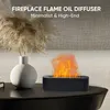 A modern black aroma diffuser with a flame effect sits on a dark table next to a white vase with dried reeds. Produktbild-Vorschau