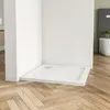 A white shower tray is shown in a corner of a modern bathroom with wooden flooring. Produktbild-Vorschau