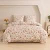 A bed with floral and rabbit patterned bedding in a bedroom. Náhľad obrázku produktu