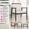 A black armchair with white cushions and a rattan back, shown with accompanying product information and smaller views of the chair. Náhled obrázku produktu