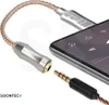 A close-up product shot of a USB-C to 3.5mm audio adapter connected to a smartphone. Náhľad obrázku produktu