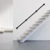 A modern interior with a staircase and a black handrail mounted on a white wall. Náhled obrázku produktu
