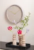 A wall clock and three vases with flowers are displayed on a shelf. Náhľad obrázku produktu