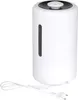 A white ultrasonic humidifier with a black top and a small gray knob is shown against a white background. A white power cord with a European plug is coiled at the bottom left. Produktbild-Vorschau
