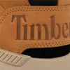 A close-up view of a brown Timberland shoe, focusing on the embossed logo and stitching. Produktbild-Vorschau