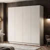 A large, modern, four-door wardrobe in a neutral color, set in a dimly lit room with a textured dark wall and a wall-mounted lamp. Produktbild-Vorschau