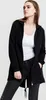 A woman wearing a black hooded jacket and jeans. Náhľad obrázku produktu