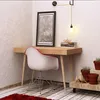 A desk with a chair and decorative items in a room corner. Anteprima dell’immagine prodotto