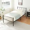 A bedroom scene with a single bed, nightstand, and window. Voir les images du produit