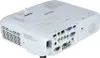 A white Epson projector is shown from a rear-diagonal angle, displaying its various input and output ports. Voir les images du produit