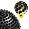 A close-up view of a black massage ball with raised nubs, with a magnified inset showing the texture and a small icon. Náhled obrázku produktu