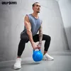 A man is performing a kettlebell squat in a gym. Produktbild-Vorschau