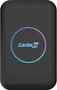 A black electronic device with a circular, multicolored light ring and a logo in the center. Produktbild-Vorschau
