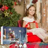 A young girl sits in front of a Christmas tree and an advent calendar, holding a gift. Produktbild-Vorschau