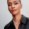 A woman wearing a black leather shirt and a silver necklace. Podgląd zdjęcia produktu