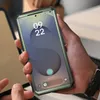 A person is holding a smartphone in a protective case. Náhľad obrázku produktu