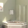 A corner bathtub with a glass shower enclosure in a bathroom. Produktbild-Vorschau