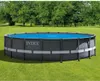 An oval above-ground swimming pool with a blue liner and gray sides, set up on a grassy lawn with trees in the background. Náhľad obrázku produktu