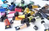 A collection of acrylic paint tubes scattered on a white surface. Anteprima dell’immagine prodotto