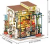 A miniature dollhouse flower shop with a greenhouse section. Náhled obrázku produktu