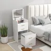 A white vanity table with a mirror and stool next to a bed. Produktbild-Vorschau
