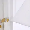 A close-up view of a white sheer curtain with a branch of yellow leaves in the foreground. Produktbild-Vorschau
