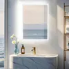A modern bathroom vanity with a marble-effect countertop and a gold faucet, featuring a lit mirror reflecting a serene seascape. Náhľad obrázku produktu