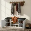An entryway shoe cabinet with a bench seat, coats, and hats hanging on a wall rack, and a basket with accessories. Náhľad obrázku produktu