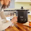 A woman is using a black Russell Hobbs slow cooker on a wooden countertop. Anteprima dell’immagine prodotto