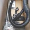 The image shows the contents of a vacuum cleaner box, including the hose, wand, and floor head. Anteprima dell’immagine prodotto