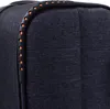 Close-up of the corner of a dark blue suitcase, showing the handle and fabric texture. Náhled obrázku produktu