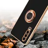 A smartphone case with a ring holder is shown on a cracked, rocky surface with fallen leaves. Produktbild-Vorschau