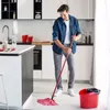 A man is mopping the floor in a modern kitchen. Anteprima dell’immagine prodotto