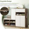 A modern shoe cabinet with a cushioned bench, displaying various shoes on its shelves and a bag hanging on the side. Anteprima dell’immagine prodotto
