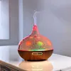 An aroma diffuser with colorful LED lights is emitting mist. Produktbild-Vorschau
