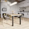 A modern dining room scene with a fireplace, a dining table with chairs, and a kitchen area. Produktbild-Vorschau