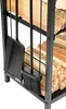 A close-up view of a black metal firewood rack filled with logs, showing the included fireplace tools. Produktbild-Vorschau