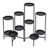 A black metal plant stand with multiple tiers. Podgląd zdjęcia produktu
