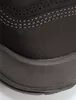 A close-up view of the toe area of a black safety shoe, showing the textured fabric and the rubber sole. Produktbild-Vorschau